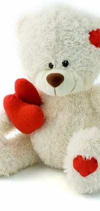 Transform your phone's home screen with this beautiful live wallpaper featuring a white teddy bear holding a red heart that symbolizes love and affection
