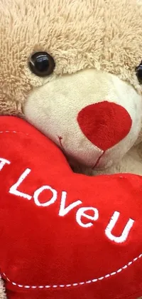 This stunning live wallpaper features a darling brown teddy bear holding a vibrant red heart, exuding love and charm