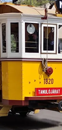 Get the perfect urban street vibe with this yellow trolley car live wallpaper