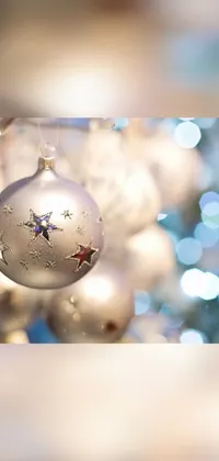 This Christmas live wallpaper for phones features a stunning close-up of a holiday ornament with glittering silver details and twinkling lights in the background