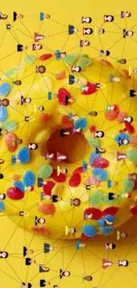 This live phone wallpaper features a delicious donut covered in colorful sprinkles resting on a vibrant yellow surface alongside an intriguing diagram of groups of people immersed in a network