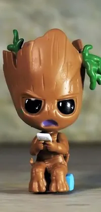 This live phone wallpaper showcases a baby Groot toy from Marvel Comics