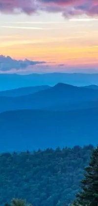 This mobile live wallpaper showcases a stunning blue sunset over the far-off Appalachian mountains and a vast forest, creating a tranquil atmosphere