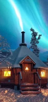 This phone live wallpaper features a cozy cabin nestled in a snow-covered forest