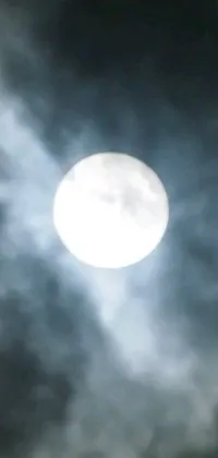 This captivating live wallpaper for your phone displays a delightful image of a plane flying in front of a full moon, set against a surreal background of swirling clouds and misty atmosphere