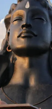 This live wallpaper showcases a magnificent statue of a woman with horns on her head in a close-up view