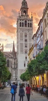 This phone live wallpaper depicts a bustling street in Seville, Spain, featuring historic baroque buildings and a striking cathedral towering over the scene