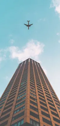 Get an immersive experience with this phone live wallpaper featuring a plane flying over a tall building