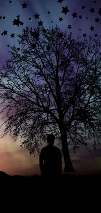 Enjoy this stunning live wallpaper featuring a man standing next to a tree, set against a technicolor sky