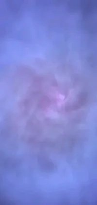 This is a phone live wallpaper featuring a blurry circular object in the sky with a dreamy mist of blue and purple vapor