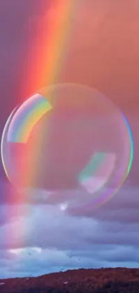 This phone live wallpaper showcases a stunning rainbow effect in the sky with a unique holographic twist
