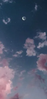 This live wallpaper is a feast for the eyes, featuring a picturesque sky filled with pink clouds and a crescent moon