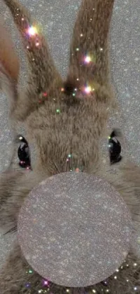 This phone wallpaper features a close-up view of a fluffy stuffed rabbit with glittering particles on its face