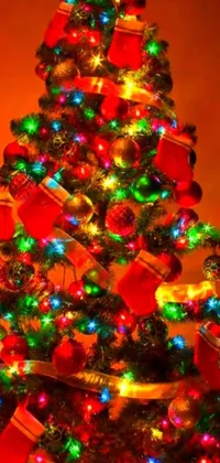 Enhance your phone's background with a festive Christmas treelive wallpaper! This design features a beautifully decorated tree illuminated with bright, colorful lights in shades of red, green, and yellow