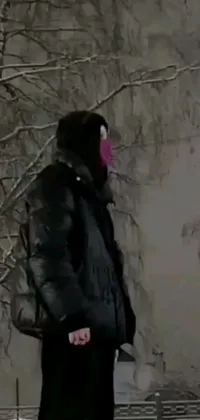 This live phone wallpaper depicts a masked person in snowy Pripyat