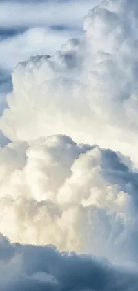This live wallpaper for your phone showcases a beautiful scene of a plane flying through a sky full of white cumulus clouds