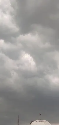 This cool phone live wallpaper features a group of white domes under a moody cloudy sky and a thunderstorm supercell in the background