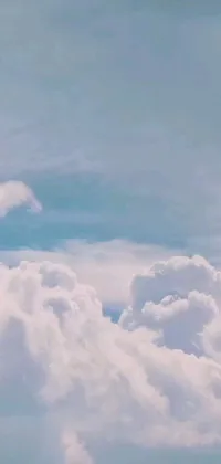 This stunning phone live wallpaper showcases a large jetliner soaring through a fluffy cumulus cloud-filled sky