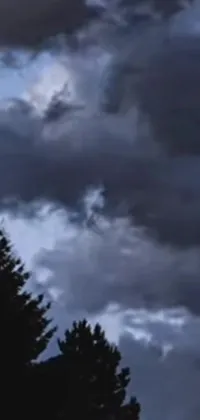 This live wallpaper depicts a large jetliner flying through a turbulent and stormy sky, leaving behind a trail of white vapor