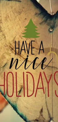 Looking for a warm and inviting live wallpaper for your phone? Check out this charming design featuring a wooden heart with the words "have a nice holidays" written on it