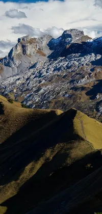 Experience the beauty of the Swiss Alps with this stunning phone live wallpaper! Feast your eyes on a lush green landscape and an aerial view of a mountain