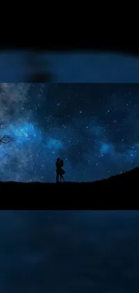 Add a romantic touch to your phone with this stunning live wallpaper featuring a couple standing on a hill under a starry night sky