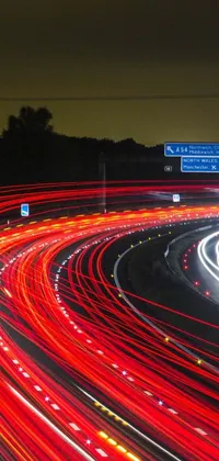This live phone wallpaper showcases a high-speed, traffic-filled highway at night