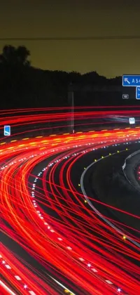 This live phone wallpaper depicts a vibrant and busy highway at night