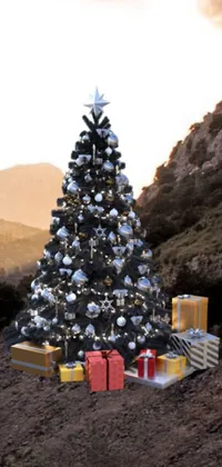 This live wallpaper boasts a stunning Christmas tree and presents in front of a snowy mountain backdrop