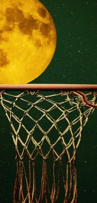 This phone live wallpaper features a basketball net with a yellowish full moon backdrop