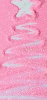 This pink Christmas tree phone live wallpaper is the perfect addition to your festive collection! The beautiful tree is covered in colorful ornaments, topped with a shining star