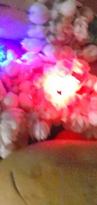 This phone live wallpaper depicts a stuffed animal with a glowing light in its mouth and a dada-style crown made of white lasers
