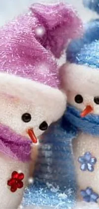 Looking for a winter-themed live wallpaper for your phone? Look no further than this cute and cozy design featuring two snowmen in a frosty wonderland! The snowmen are adorned with traditional features such as coal eyes and carrot noses, and are smiling mischievously at one another