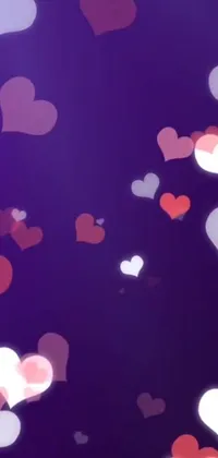 This live wallpaper for your phone boasts a stunning sight of numerous hearts drifting elegantly on a deep, purple backdrop