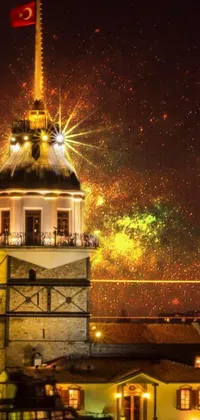 This live wallpaper features a tall, neoclassical tower with a flag at its peak, surrounded by a colorful display of fireworks