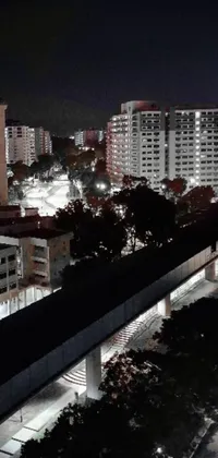This live wallpaper showcases an aerial view of a vibrant and dynamic city at night, complete with its bustling MRT trains
