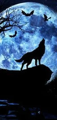 This live phone wallpaper features a silhouette of a wolf standing against a full moon amidst blue clouds