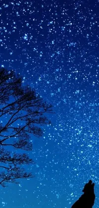 This live phone wallpaper features a serene scene of a person using their phone while sitting under a tree under a clear night sky