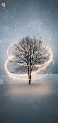 This phone live wallpaper showcases a beautiful piece of digital art featuring a majestic tree set against a snowy background