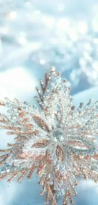 This phone live wallpaper features a stunning snowflake on a blue blanket with a baroque vibe