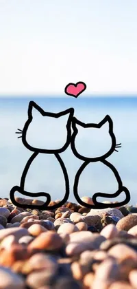 This romantic live wallpaper features a cute cartoon picture of two cats sitting side-by-side on a beach