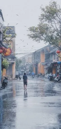 This phone live wallpaper features a beautiful hyperrealistic painting of a person walking on a rain-soaked street, surrounded by the serene ambiance of a traditional Vietnamese temple