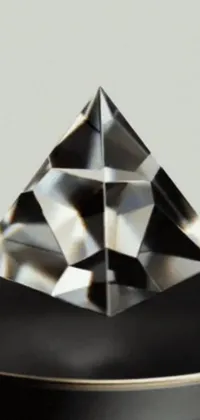 This live wallpaper for your phone features a sparkling diamond on a black table