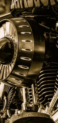 This phone live wallpaper features a black and white photo of a motorcycle and airplane engine, with intricate details and vivid colors