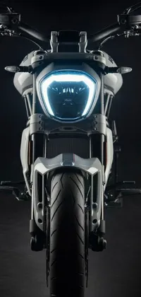This phone live wallpaper showcases a close-up of a motorcycle, providing a portrait image on a black background