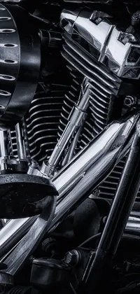 This phone live wallpaper features a stunning monochrome photograph of a motorcycle engine