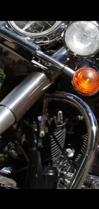 This phone live wallpaper showcases a close-up shot of a motorcycle against a backdrop of trees