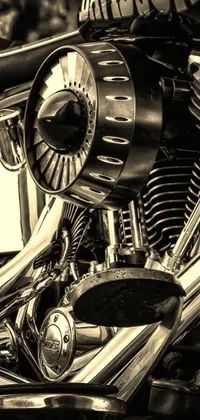 This stunning phone live wallpaper features a black and white photograph of a motorcycle captured in a stipple style, showcasing the intricate details of the engine in vivid colors