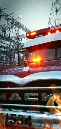 This phone live wallpaper depicts a rugged and macho truck with its lights on