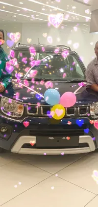 This live phone wallpaper showcases two men grinning happily beside a car in a mall setting